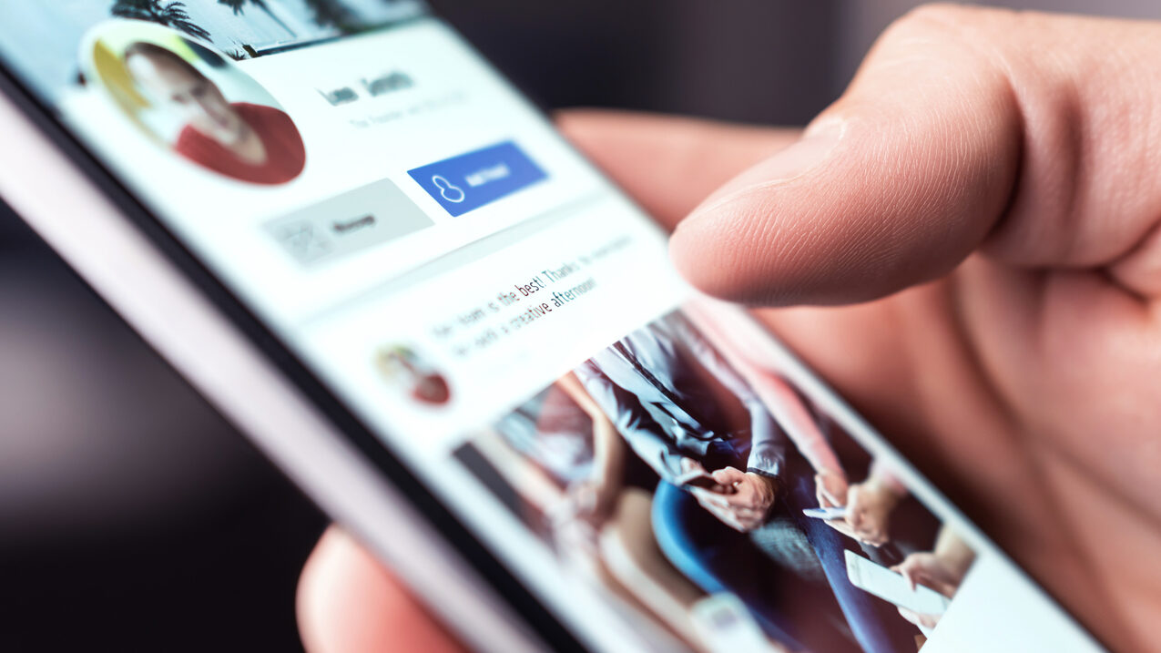 Close-up of a person using the LinkedIn mobile app, highlighting the platform’s importance and popularity for professional networking and business growth.