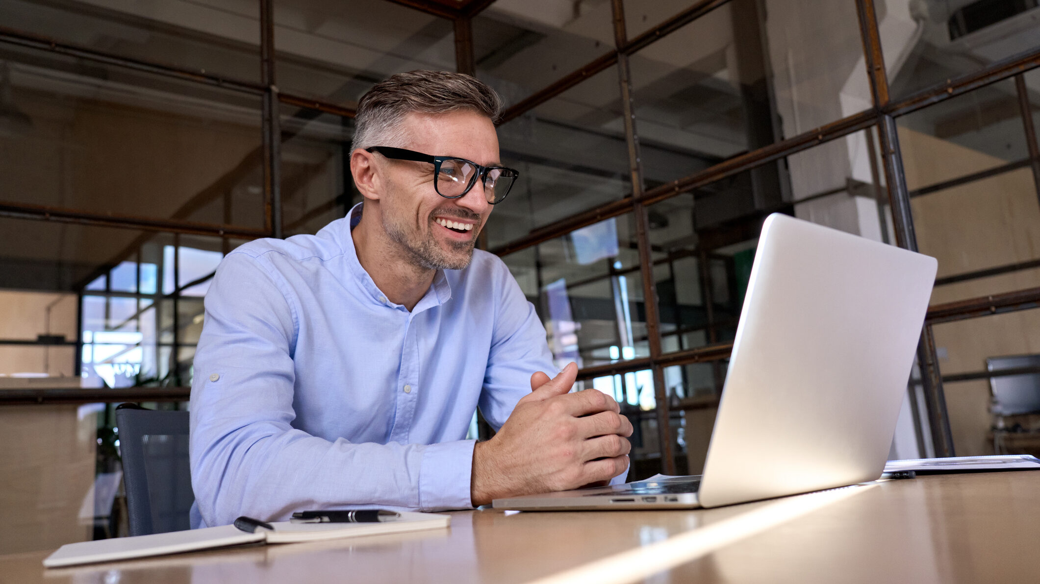 Professional businessperson on a Zoom video call, representing how LinkedIn connections can lead to meetings with overseas real estate investors and corporate relocation prospects.