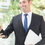 Real estate agent handing over keys to investor client during Dubai off-plan property handover process.