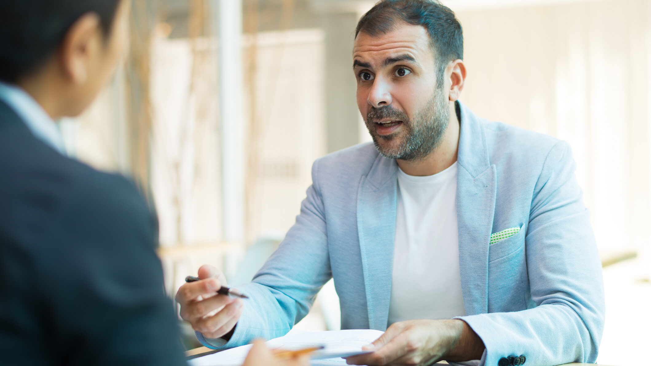 Dubai real agency owner discussing service-level agreements (SLAs) for speed-to-lead and follow-up with a new agent during a coaching meeting about the brokerage's response time standards to convert enquiries.