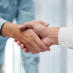 Real estate agent handshake with client — lead qualification and closing in Dubai, UAE property market; BANT/CHAMP framework, WhatsApp follow-up, CRM pipeline.