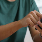 Close-up of a person using a smartphone for WhatsApp messaging, representing how UAE real estate agents engage buyers through mobile-first communication channels to increase lead conversion, response speed, and viewing bookings.