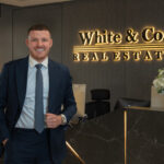 Robert English, Director of Sales at White & Co. Real Estate Dubai, in the office lobby—leadership and coaching for high-performing brokers.