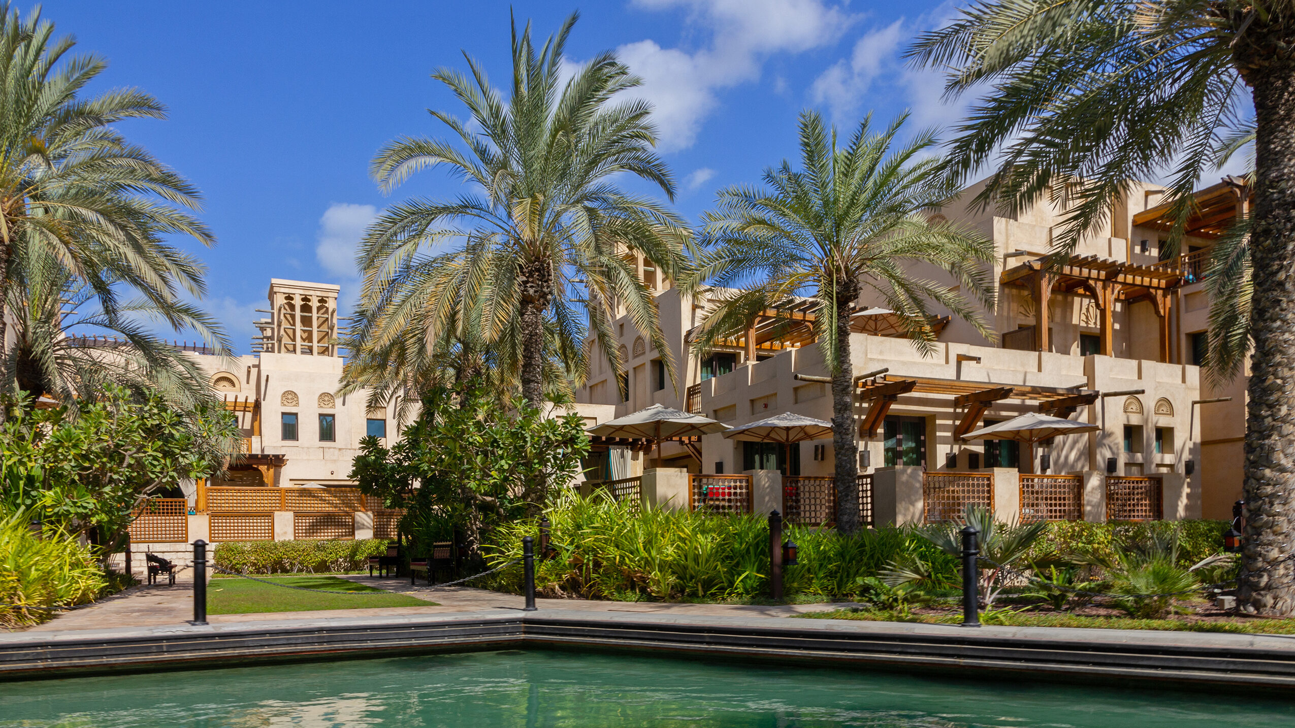 Luxury residential community with palm-lined lagoon and waterfront villas in Dubai, showcasing lifestyle amenities in off-plan real estate developments