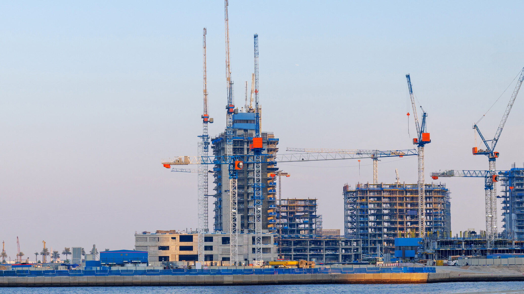 Off-plan real estate construction in Dubai with multiple residential towers under development, illustrating the regulated off-plan property sales process for agents and investors