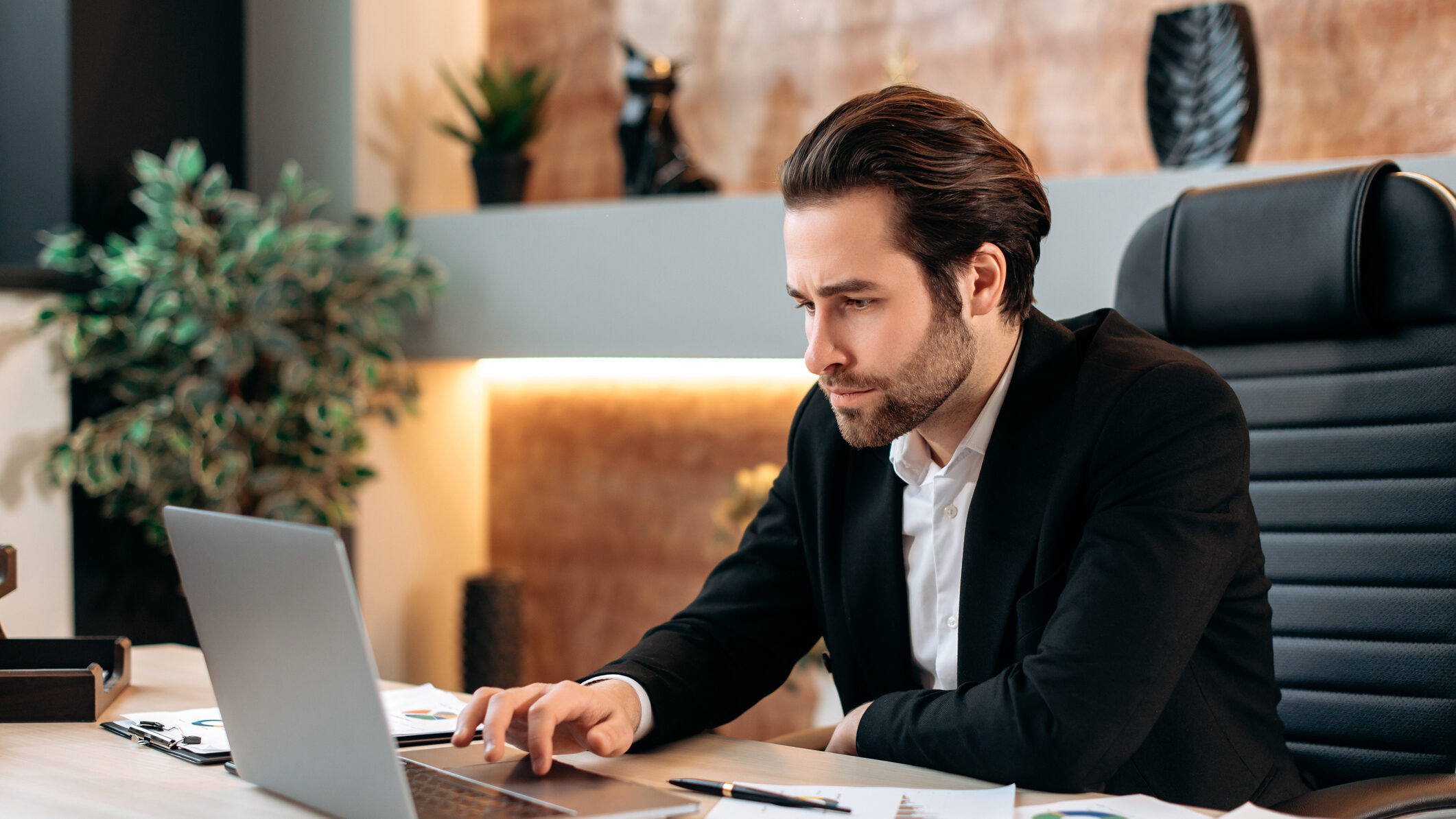 Real estate agency founder reviewing budget and cash flow projections on a laptop, planning a 90-day launch strategy for a new UAE real estate brokerage.