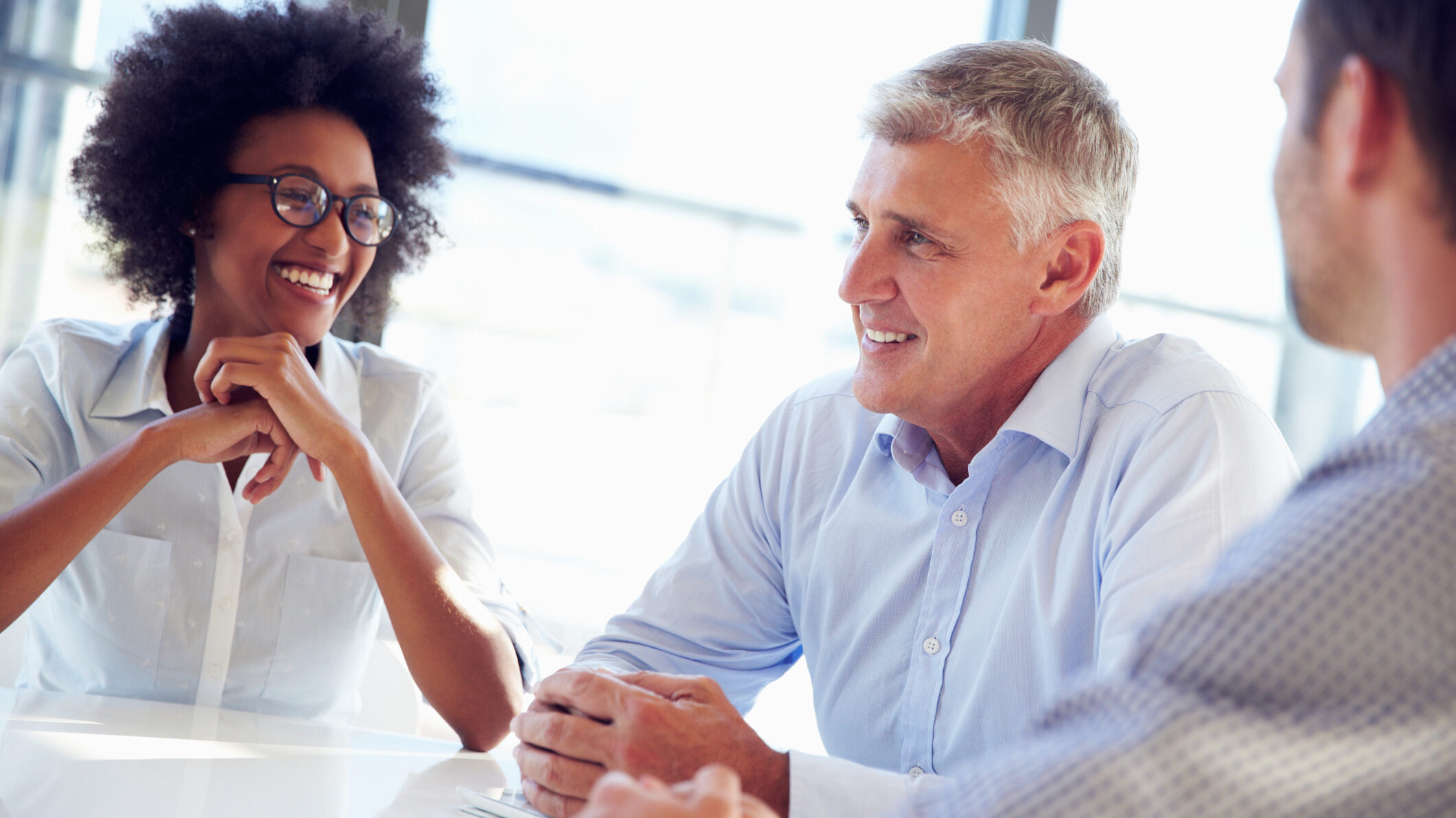 Business team in a meeting discussing authentic vs borrowed leadership styles for Dubai real estate agency owners, focused on trust, communication, and decision-making.