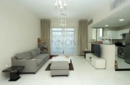Living Room image for: Apartment - 1 Bedroom - 2 Bathrooms for sale in Plazzo Heights - Jumeirah Village Circle - Dubai, Image 1