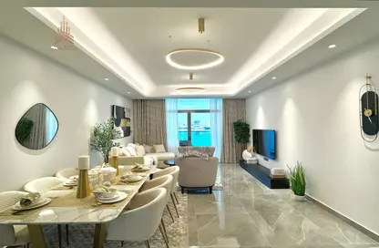 Living / Dining Room image for: Apartment - 2 Bedrooms - 2 Bathrooms for sale in Ajman Creek Towers - Al Rashidiya 1 - Al Rashidiya - Ajman, Image 1