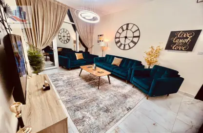 Living Room image for: Apartment - 1 Bedroom - 2 Bathrooms for rent in Queen Tower - Al Qasba - Sharjah, Image 1