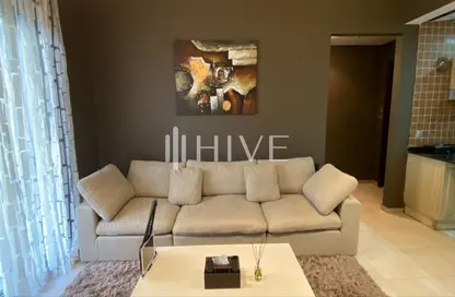 Living Room image for: Apartment - 1 Bedroom - 2 Bathrooms for rent in Hamza Tower - Dubai Sports City - Dubai, Image 1
