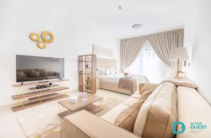 Living Room image for: Apartment - 1 Bathroom for rent in Amara Residences - Jumeirah Village Circle - Dubai, Image 1