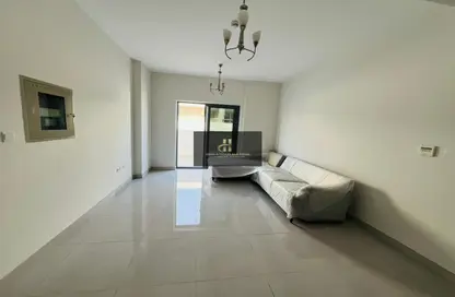 Living Room image for: Apartment - 1 Bedroom - 2 Bathrooms for rent in Jude Residence - Nad Al Sheba 1 - Nad Al Sheba - Dubai, Image 1
