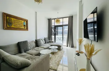 Living Room image for: Apartment - 1 Bedroom - 2 Bathrooms for sale in Golf Horizon Tower A - Golf Horizon - DAMAC Hills - Dubai, Image 1