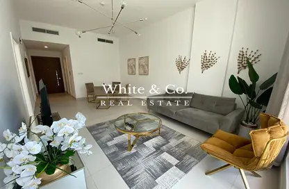 Living Room image for: Apartment - 1 Bedroom - 2 Bathrooms for sale in Prime Views by Prescott - Meydan Avenue - Meydan - Dubai, Image 1