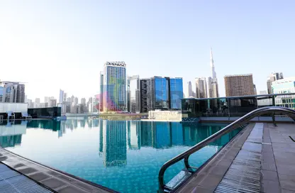 Pool image for: Apartment - 1 Bedroom - 2 Bathrooms for rent in Art XV - Business Bay - Dubai, Image 1
