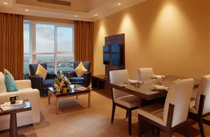 Living / Dining Room image for: Hotel  and  Hotel Apartment - 1 Bedroom - 1 Bathroom for rent in Jannah Burj Al Sarab - Mina Road - Tourist Club Area - Abu Dhabi, Image 1