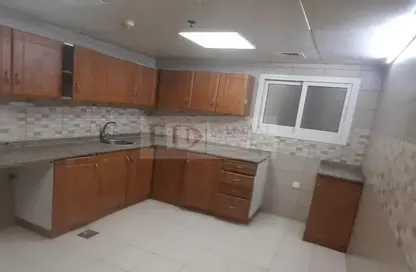 صورة لـ مطبخ شقة - 2 غرف نوم - 3 حمامات للايجار في قصر قرطبة - واحة السيليكون - دبي ، صورة رقم 1
