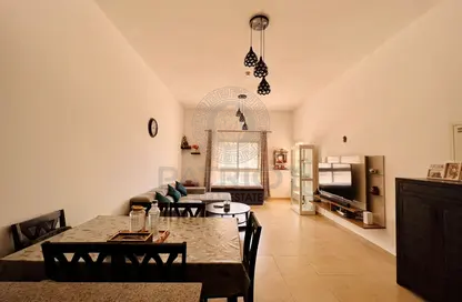 Living / Dining Room image for: Apartment - 1 Bedroom - 1 Bathroom for sale in Al Thamam 22 - Al Thamam - Remraam - Dubai, Image 1