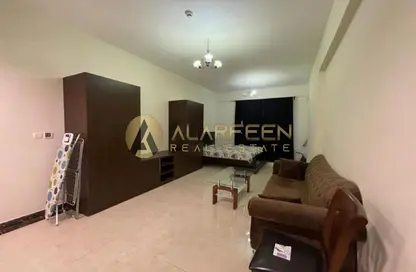 Living Room image for: Apartment - 1 Bathroom for sale in Pantheon Boulevard - Jumeirah Village Circle - Dubai, Image 1