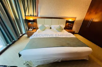 Room / Bedroom image for: Apartment - 1 Bedroom - 2 Bathrooms for rent in Blumont Capital Hotel - Danet Abu Dhabi - Abu Dhabi, Image 1