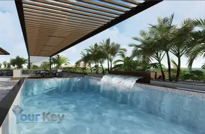 Pool image for: Apartment - 1 Bedroom - 2 Bathrooms for sale in Empire Residence - Jumeirah Village Circle - Dubai, Image 1