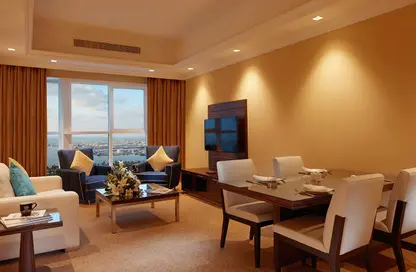 Living / Dining Room image for: Hotel  and  Hotel Apartment - 1 Bedroom - 1 Bathroom for rent in Jannah Burj Al Sarab - Mina Road - Tourist Club Area - Abu Dhabi, Image 1