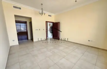 Empty Room image for: Apartment - 1 Bedroom - 2 Bathrooms for rent in Hamza Tower - Dubai Sports City - Dubai, Image 1