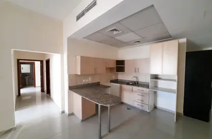 Kitchen image for: Apartment - 2 Bedrooms - 3 Bathrooms for rent in Madison Residences - Majan - Dubai, Image 1