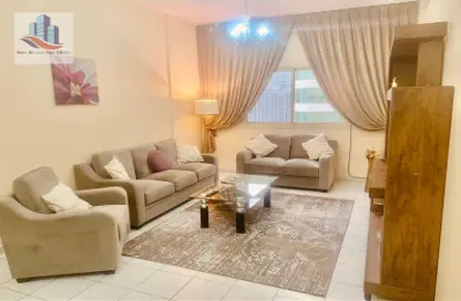 Living Room image for: Apartment - 2 Bedrooms - 2 Bathrooms for rent in Al Shahid Tower - Al Qasba - Sharjah, Image 1