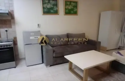 Living Room image for: Apartment - 1 Bathroom for rent in Hamza Tower - Dubai Sports City - Dubai, Image 1