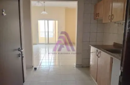 Kitchen image for: Apartment - 1 Bathroom for rent in France Cluster - International City - Dubai, Image 1