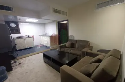 Living Room image for: Apartment - 1 Bedroom - 1 Bathroom for rent in Al Saman Tower - Hamdan Street - Abu Dhabi, Image 1